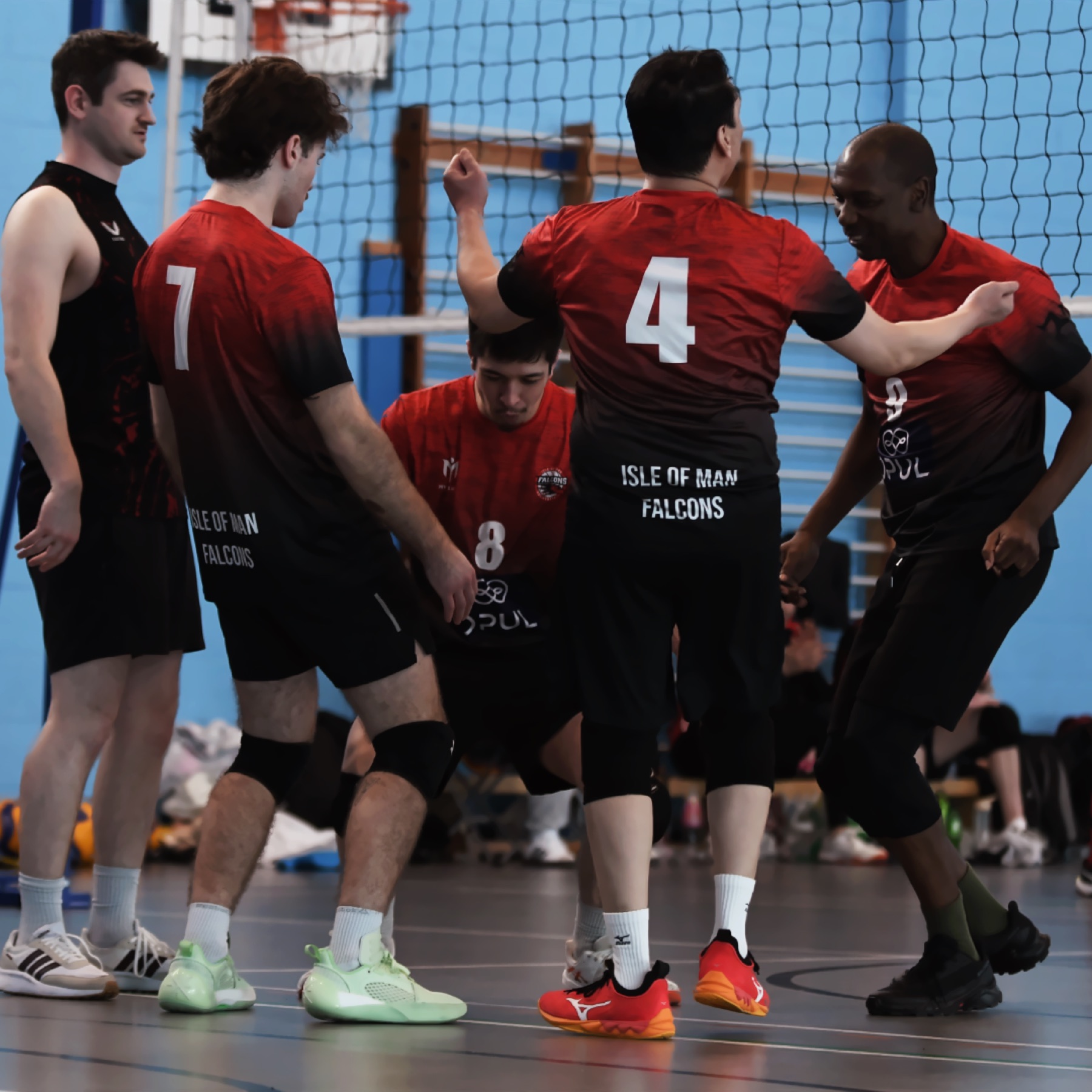 Isle of Man Falcons players celebrating together on court