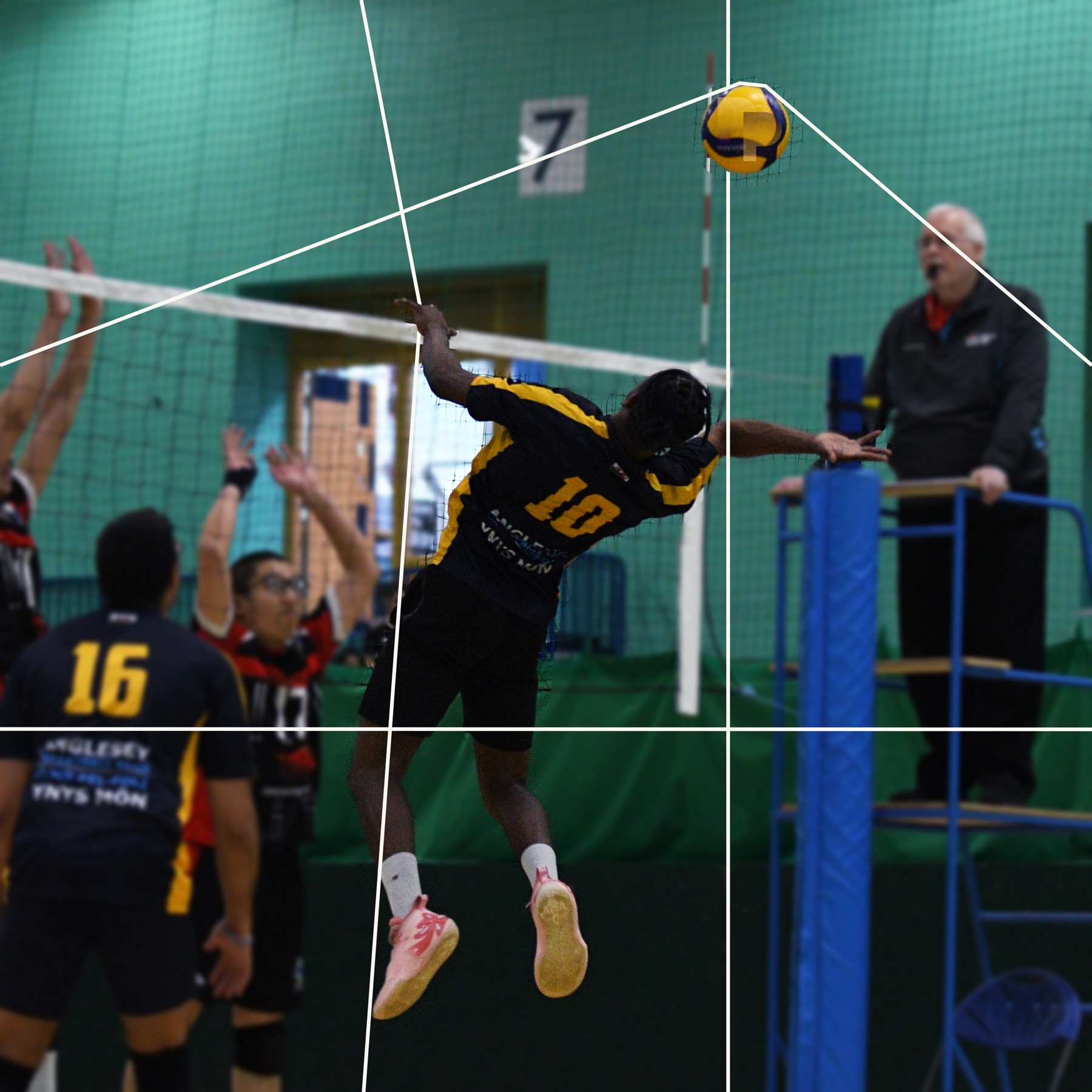 A spiker hangs mid-air at the net, white lines tracing the geometry of the attack